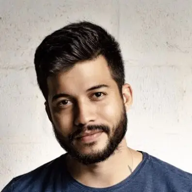 Barber 1 young man with beard smiling and wearing a  brown shirt